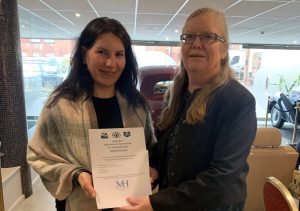 Mihaela with her V&V Employer of the Year Award