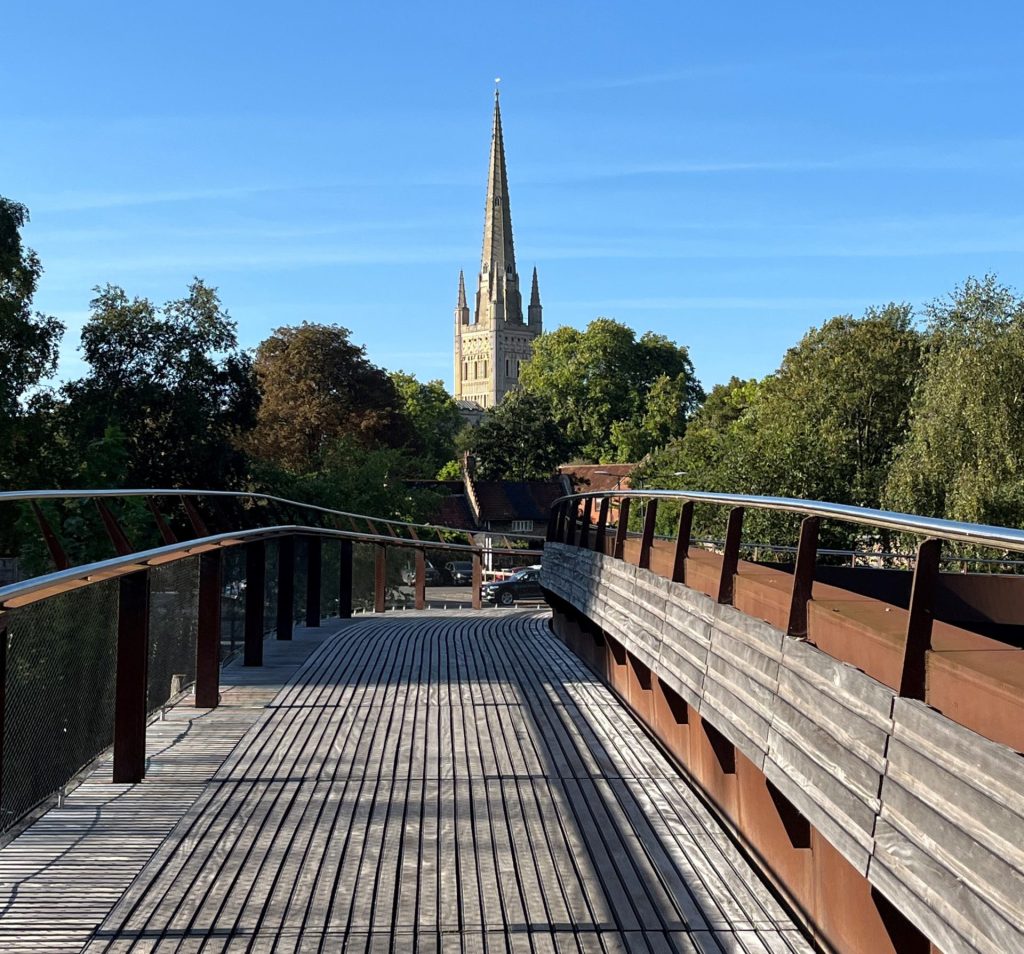 Norwich Cathedral Spire in the sunshine from the Friendship Bridge over the River Wensum. Best place to live in in the UK.