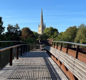 Norwich Cathedral Spire in the sunshine from the Friendship Bridge over the River Wensum. Best place to live in in the UK.